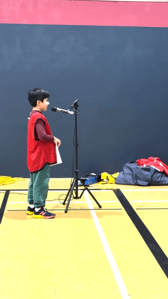 Young club member speaking at microphone