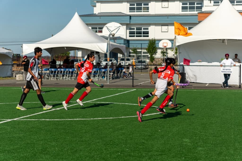 Girls running with ball during outdoor tournament