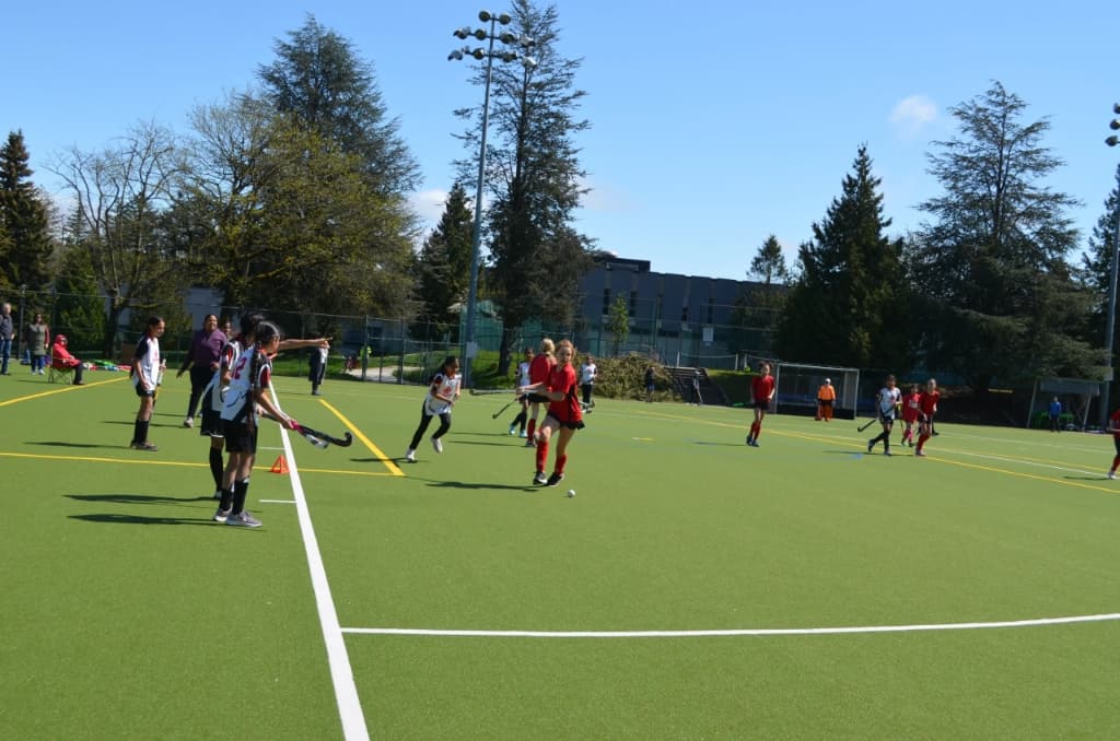 Full field hockey match in action